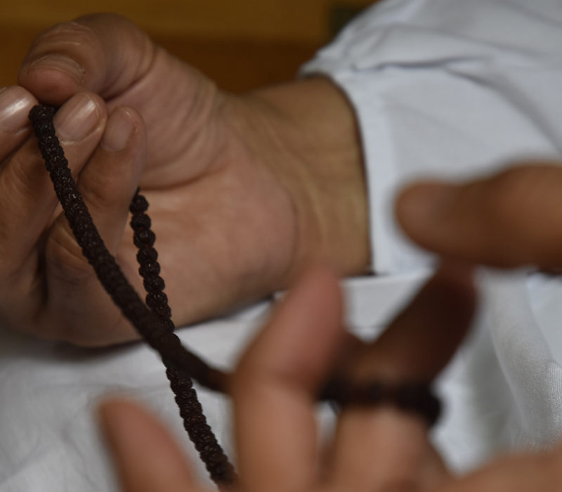 monk hands with beads