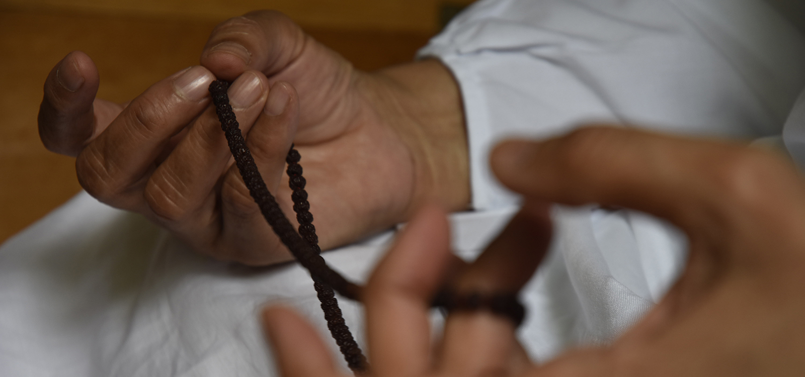 monk hands with beads