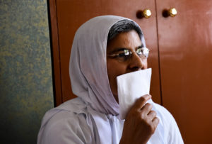 Jain monk covering her mouth